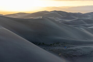 Serene sand dunes at sunrise