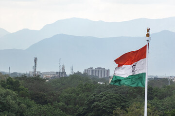 A large Indian national flag flies proudly in Madurai, set against a stunning backdrop of distant...