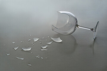 Broken wine glass with shattered fragments