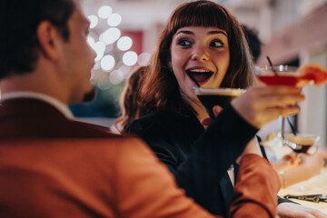 A vibrant scene of friends celebrating together with cocktails in hand, enjoying a lively...