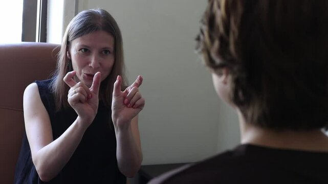 Woman using sign language during conversation