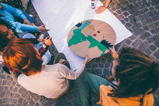 Students designing a model of earth pollution for environmental project