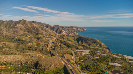 Drone Capture of Nerja's Seaside and Hills at Sunset