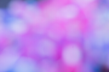 features an abstract, colorful blur with shades of pink, purple, and blue, creating a dreamy and soft bokeh effect.