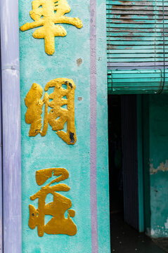 Yellow kanji on turquoise wall in Georgetown, Malaysia