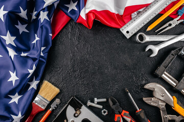 American tools arranged around the national flag on a dark background, symbolizing labor, craftsmanship, and patriotism in the United States, copy space