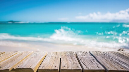 Fototapeta premium Scenic view of a wooden pier on a bright sunny day overlooking turquoise ocean waters and white sandy beach