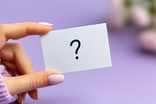 Hand holding blank white card with question mark over purple background for mystery concept - Powered by Adobe