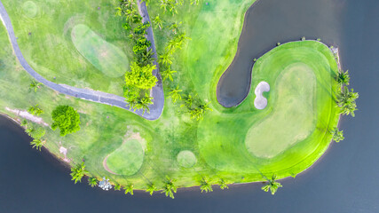 Aerial top view golf course with lush greens, green fairway and sand bunker, Golf course green grass and trees fairway and putting green, Beautiful golf course.