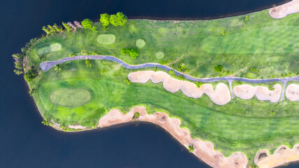 Aerial top view golf course with lush greens, green fairway and sand bunker, Golf course green grass and trees fairway and putting green, Beautiful golf course.