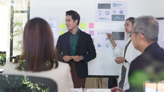 Professional business team analyzing marketing data while presenting strategic insights during collaborative meeting in modern office workspace. - Powered by Adobe