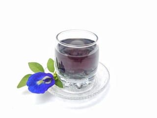 Butterfly pea flower boiled water in glass on white background. healthy drink lifestyle