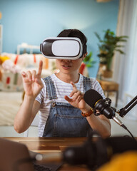 Excited japanese woman wear virtual goggles at home studio