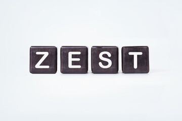 The concept word ZEST is assembled from wooden cubes. emphasizing motivation and creativity concept