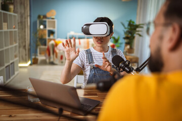 Excited japanese woman wear virtual goggles at home studio