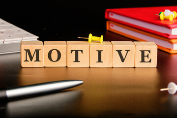 The concept word MOTIVE is assembled from wooden cubes. business motivational concept