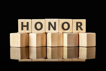 The HONOR concept word is assembled from wooden cubes. ethics, respect, code, honesty, integrity...
