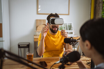 man wear virtual goggles while record podcast at home studio