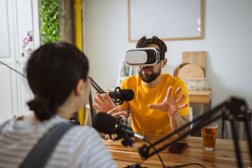 man wear virtual goggles while record podcast at home studio
