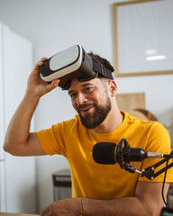 man wear virtual goggles while record podcast at home studio