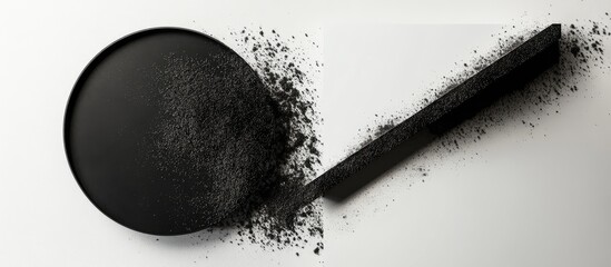 Black powder dispersing from a circle to a line