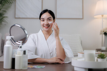 Beautician applying cream on face during skincare routine