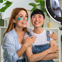 multicultural females live streaming and applies patches under eyes