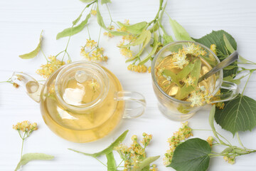 cup of herbal tea with linden flowers on wooden background