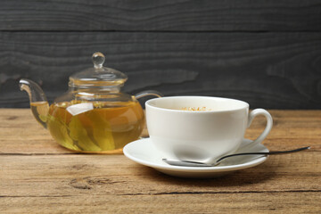 cup of herbal tea with linden flowers on wooden background
