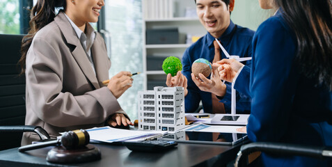 Professional team discusses clean energy and real estate contracts with wind turbines, eco globe, and gavel for sustainability, law