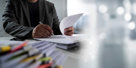 Signing paper work person business suit reviewing documents desk office setting, with focus hands and papers, conveying professionalism and work