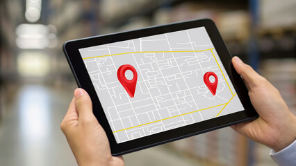 Global supply chain automation and sustainability shown with digital map on tablet in warehouse