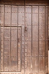Fototapeta premium Old wooden door with wrought iron details in Villanueva de los Infantes town