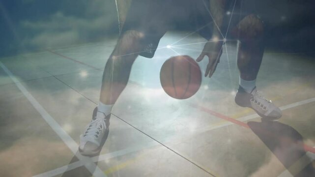 Athlete gripping ball performing low crossover dribble with graphic overlay showing sports training