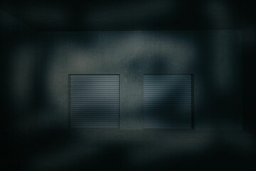 Flat illustration showing two closed metal roll-up doors in dim concrete warehouse, shadows casting