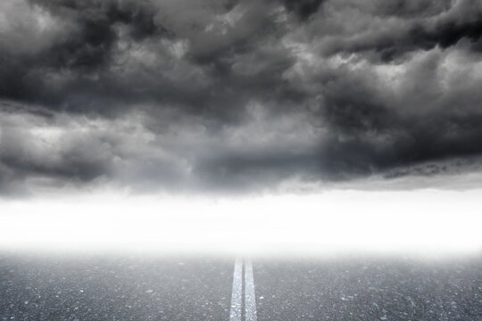 Fototapeta Flat design showing empty asphalt road with faded center line leading into fog under storm clouds