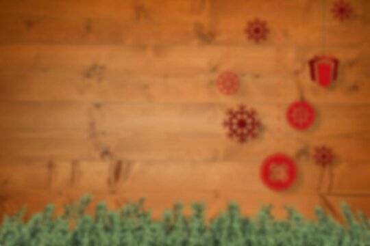 Fototapeta Blurred christmas decorations hanging over wood