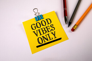 Good Vibes Only. Message on Yellow Note with Pen, Pencil, and Stationery on Desk