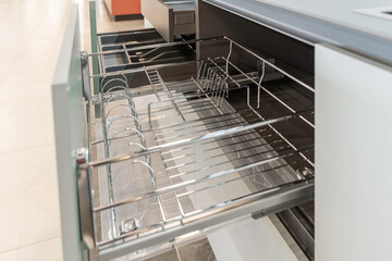 an open drawer for drying dishes. built-in kitchen. minimalistic design. built-in furniture.