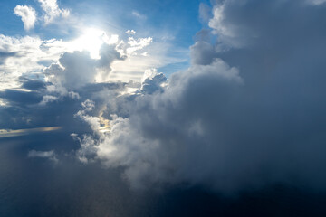Dramatic sky with sunbeams and clouds seen from an airplane