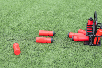 Training session equipment scattered across a green field during practice