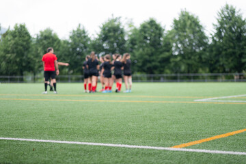 Young athletes practice teamwork on a vibrant soccer field in summer