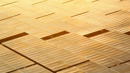 Aerial view of a solar farm with rows of reflective solar panels glowing in golden sunlight, capturing the essence of renewable energy and sustainable power production.
