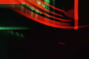 Dark, grainy abstract with red and green light streaks, motion blur, grungy texture, and a digital glitch effect, perfect for cyberpunk aesthetics or distorted media themes