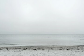 Gray, overcast beach scene. Calm, empty shoreline