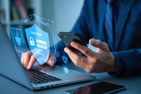 Businessman using laptop and smartphone with secure digital login interface