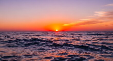 Obraz premium Fiery Sunset over the Ocean A Serene Seascape of Tranquil Waters and Vivid Colors