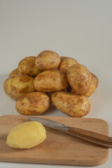 raw potatoes on a wooden board