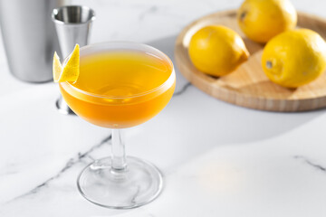 Paper plane cocktail on white marble background. Copy space