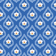 A seamless ikat-style pattern featuring delicate white orchids set against a rich royal blue background. This elegant design blends traditional textile aesthetics with modern floral motifs